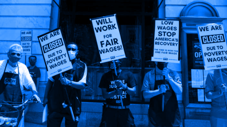 Strikers holding signs at a protest